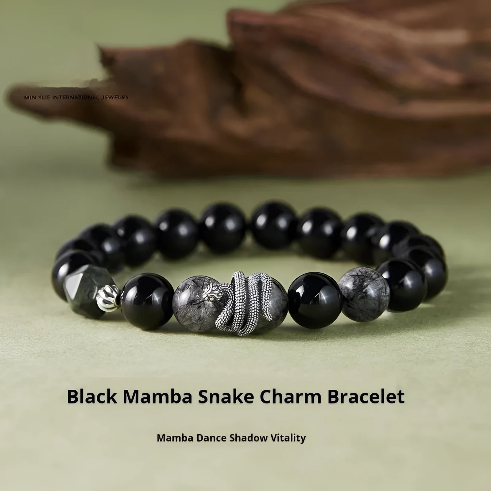 Men's black obsidian and sterling silver snake bracelet with retro design on a wrist.