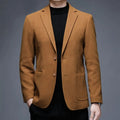 Men's solid colour woolen suit jacket with loose fit and round hem in winter setting.