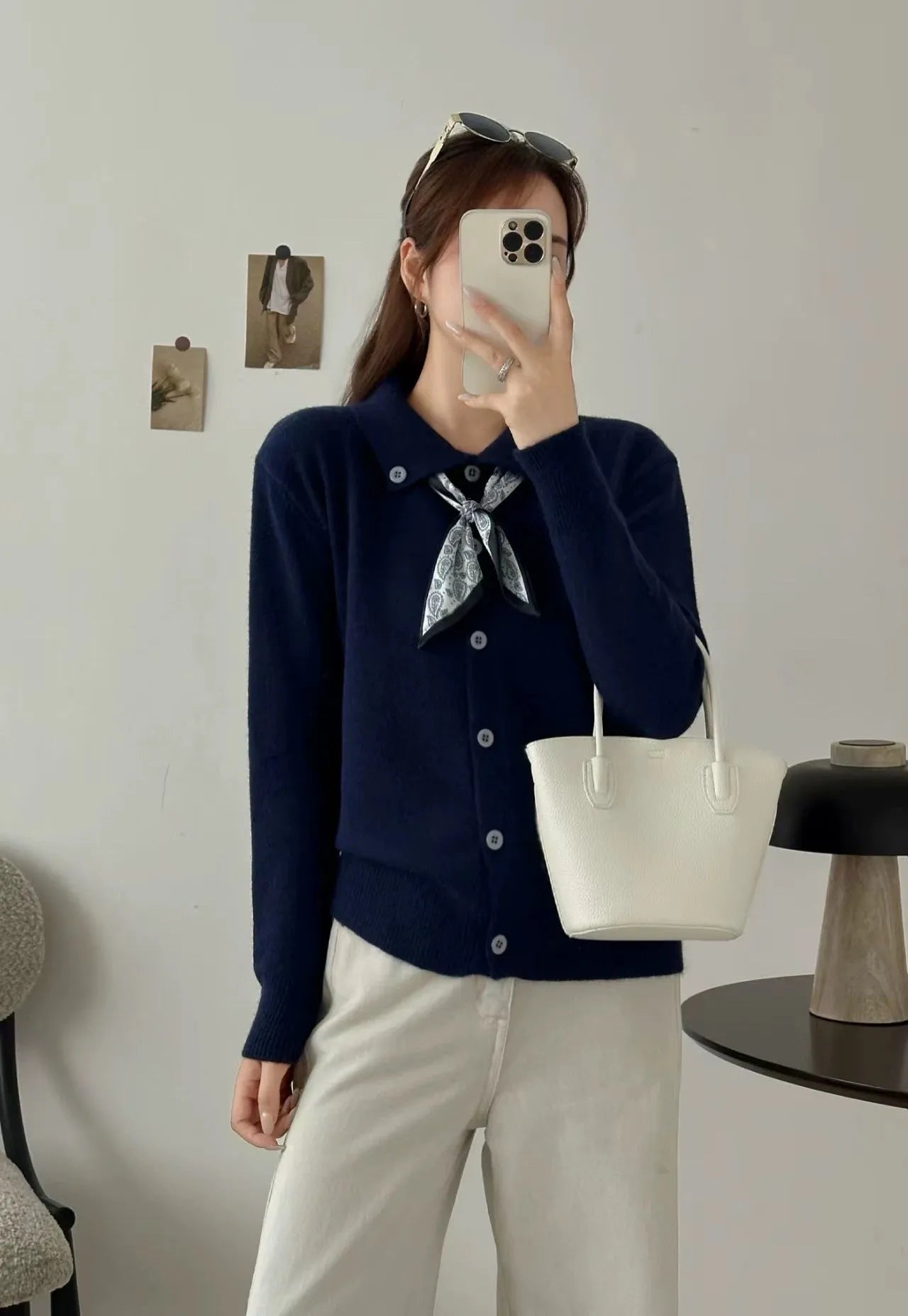 Milky white acrylic cardigan sweater with lapel collar and scarf trim detail, long sleeves.