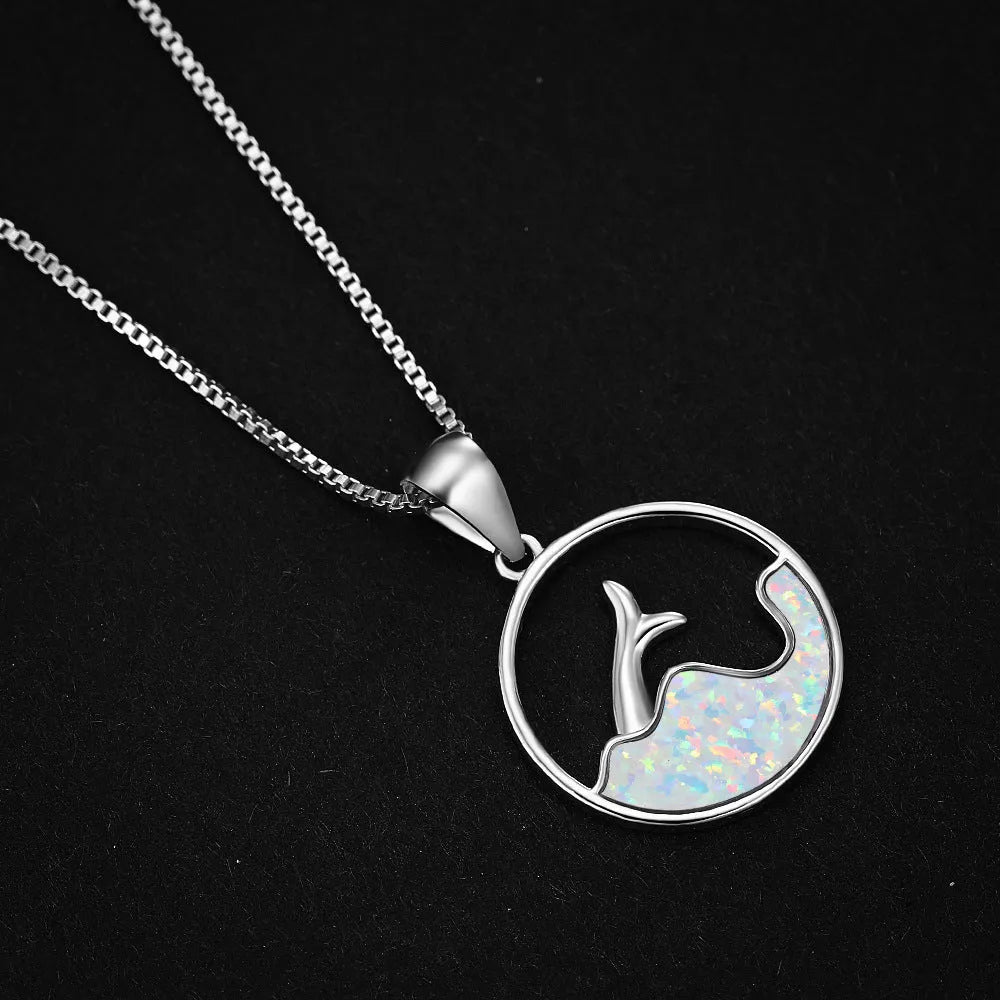 Geometric sea fishtail pendant necklace with a round blue opal and white gold electroplated finish.