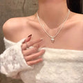 Double-layer brushed heart pendant necklace on model showing adjustable chain length