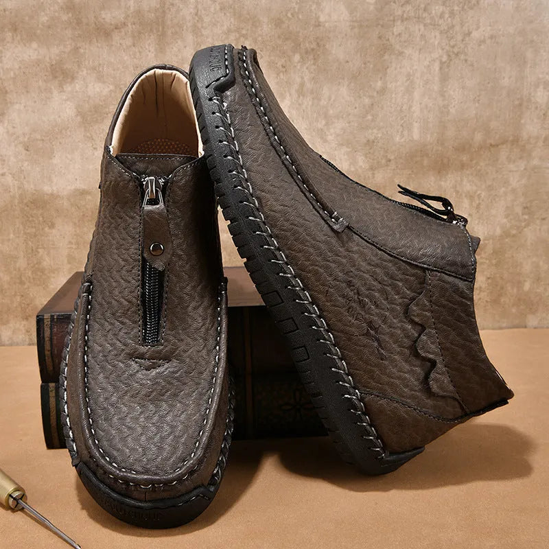 Men's brown slip-on leather loafers with round toe and rubber sole shown from side view