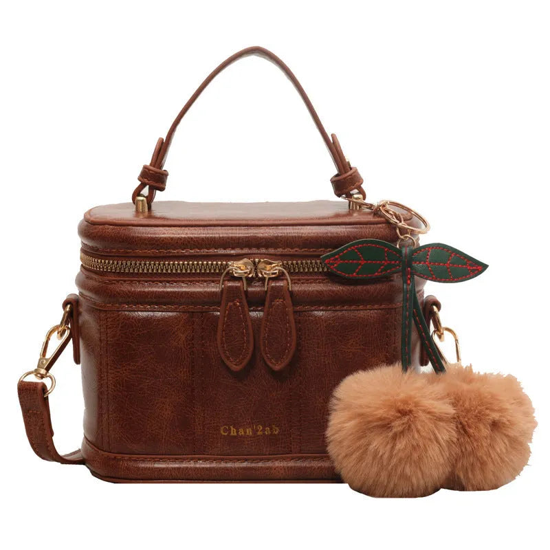 Box bucket bag in PU material with sewing line detail, available in Black, Brown, and Coffee, includes a free pendant