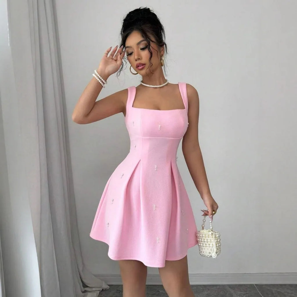 Pink high-waist suspender dress with A-line skirt and sleeveless design, made from polyester.