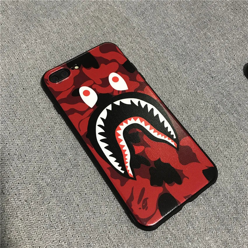 Frosted silicone phone case with shark mouth design in red, green, gray, and pink colours