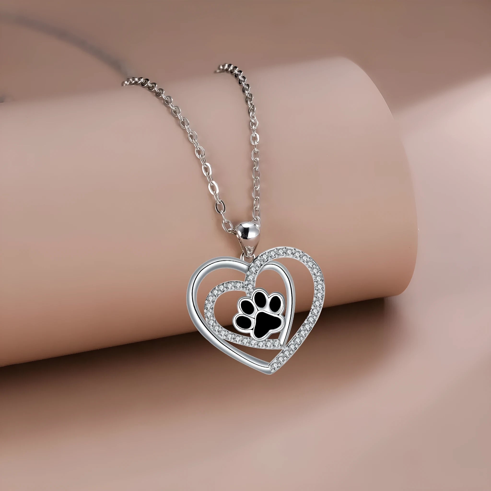 Women's necklace with heart-shaped dog paw pendant on cross chain