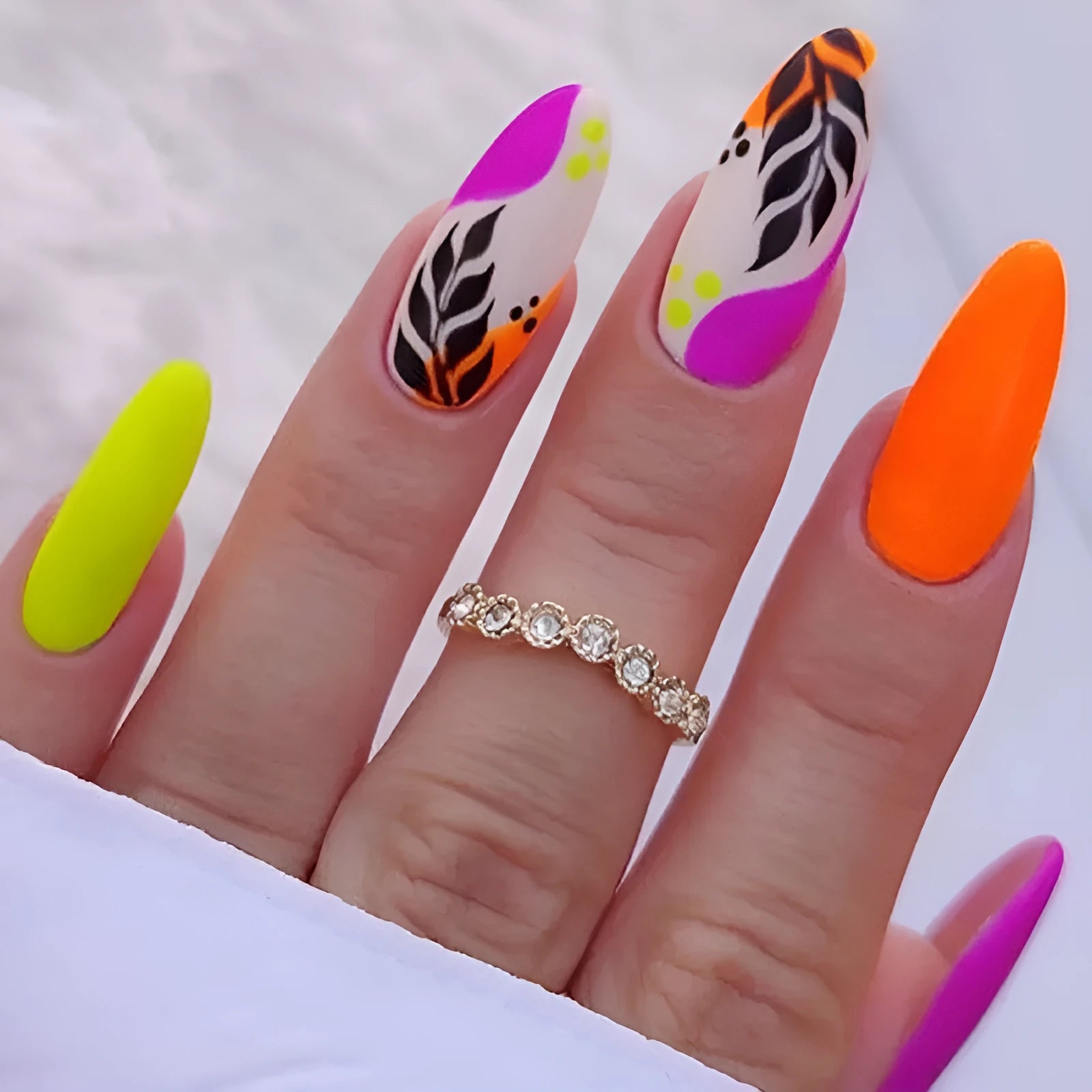 Wear Armour medium almond shaped frosted nail stickers showing four designs: French leaves, leopard print, macarons, and colour plating.