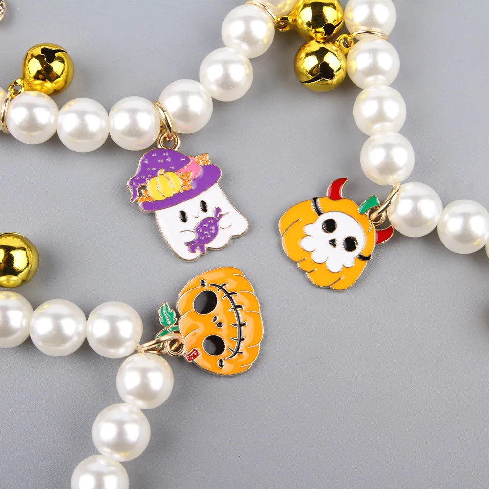 Simulated pearl necklace pet collar decoration with a pumpkin charm for Halloween.