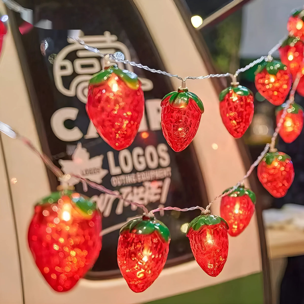 Warm strawberry-shaped LED string lights with IP66 protection, available in lengths from 1.5 m to 22 m.