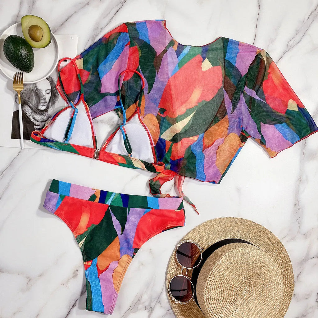 Red women's nylon split swimsuit on a hanger, showing printed design and bikini style.