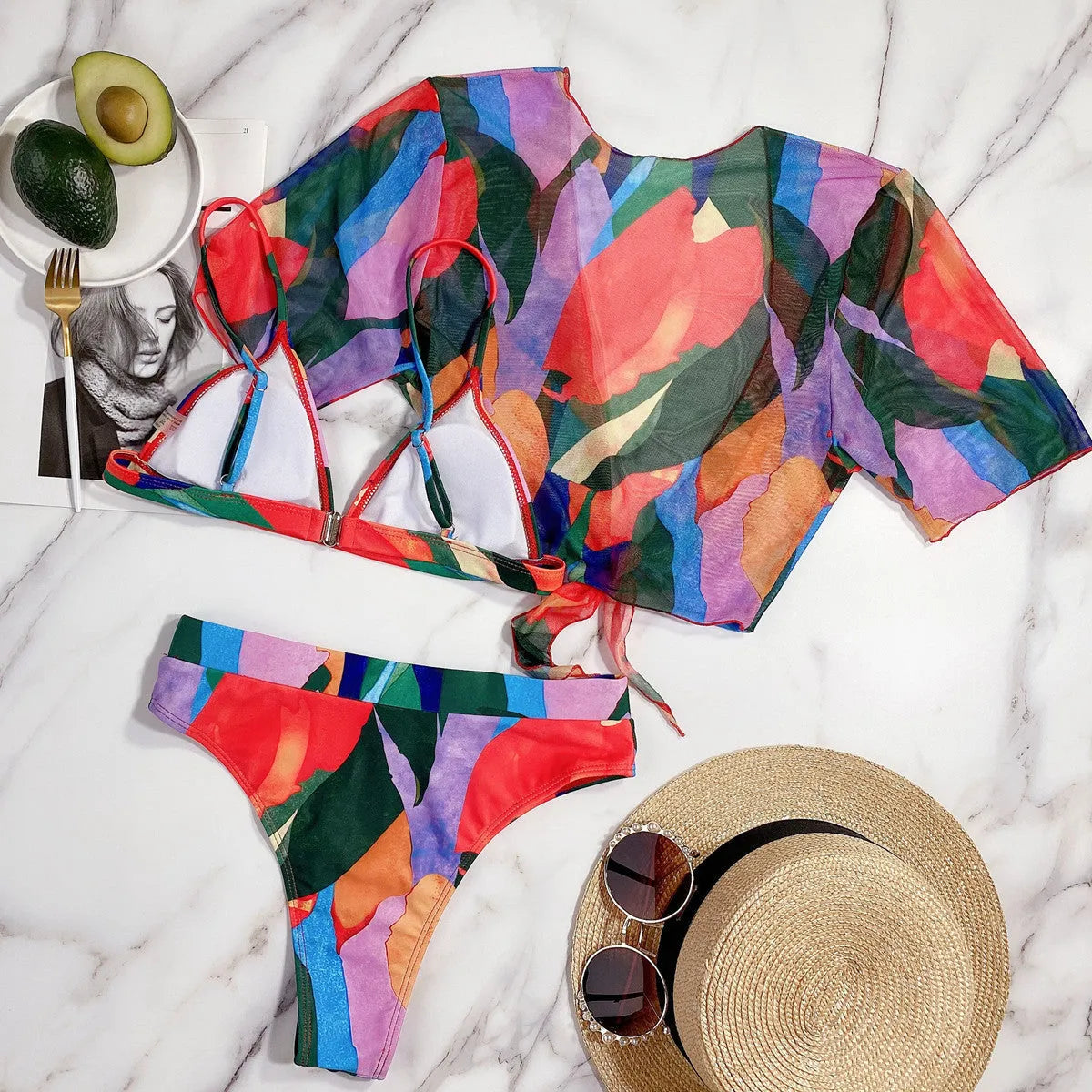 Red women's nylon split swimsuit on a hanger, showing printed design and bikini style.