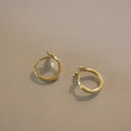 Sterling silver fishtail hoop earrings in gold and white gold finishes, 8mm inner diameter.