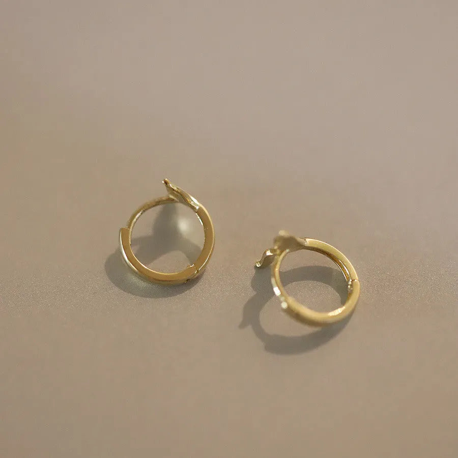 Sterling silver fishtail hoop earrings in gold and white gold finishes, 8mm inner diameter.