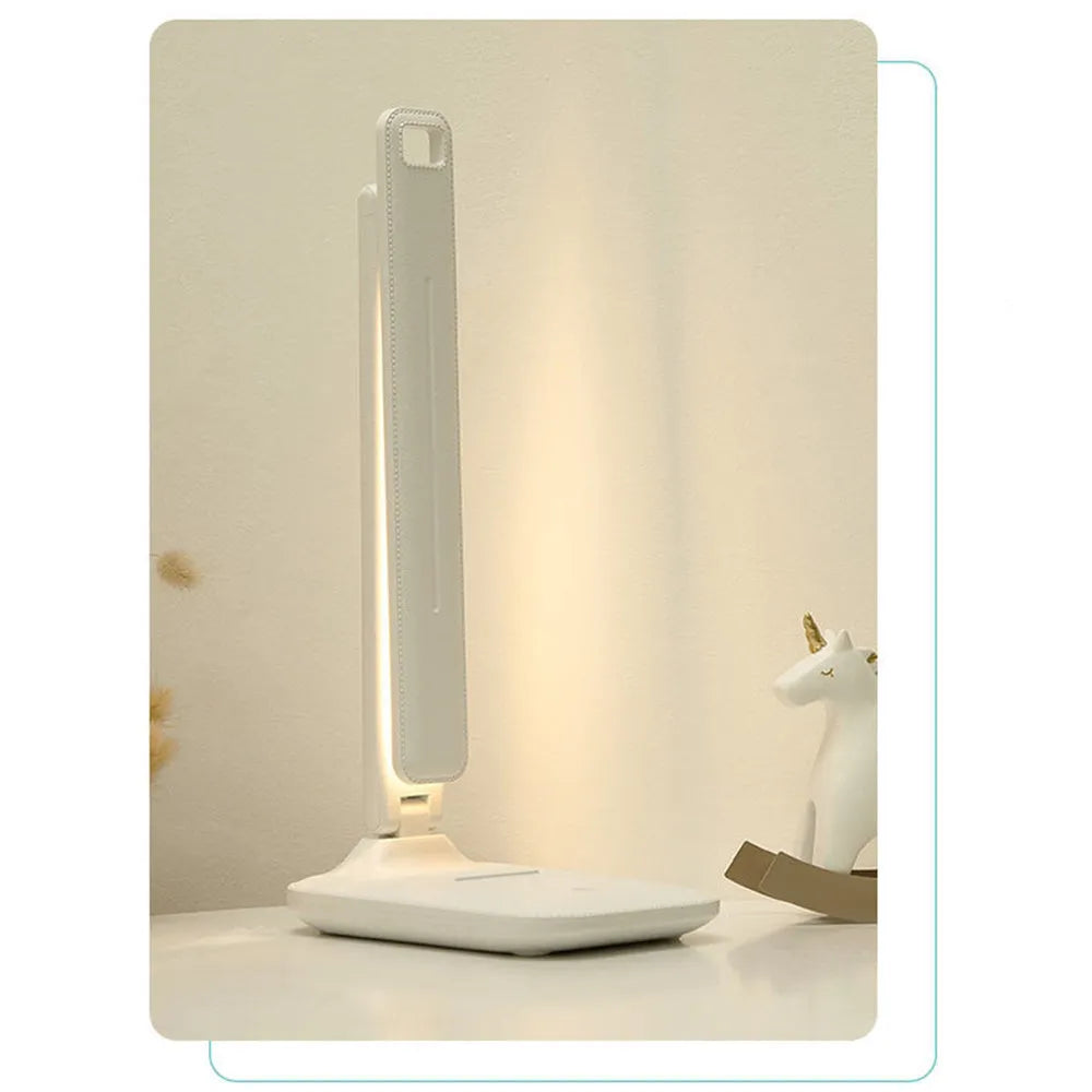 White plastic touch dimming bedside lamp with USB charging cable.