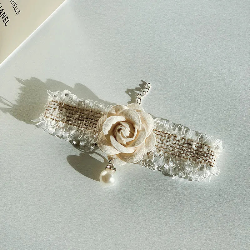 Magnolia flower pet collar accessory with chain in black on white background