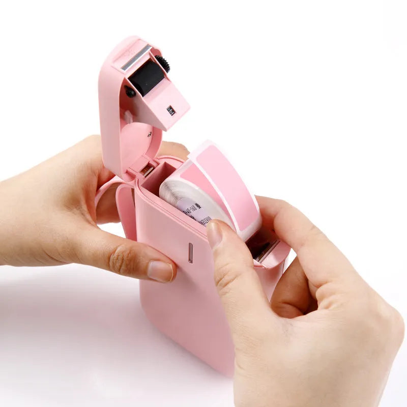 D11 Bluetooth thermal label printer in black, white, pink, or green, shown with smartphone app and printed labels.