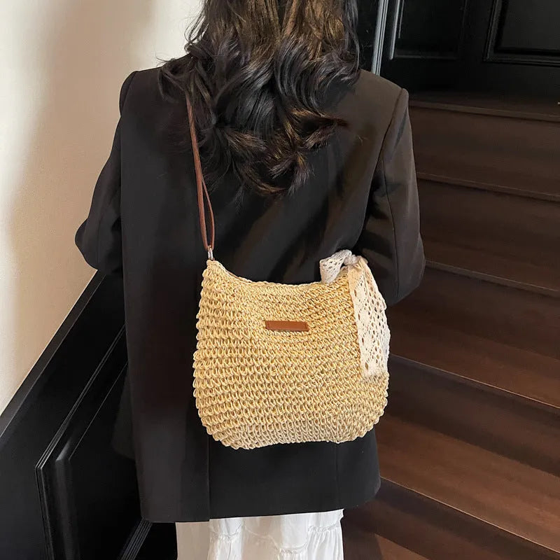Women's straw woven messenger bag with hollowed design in khaki colour showing square shape