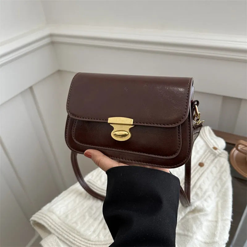Retro-style square handbag in soft PU leather showing horizontal structure and shoulder strap