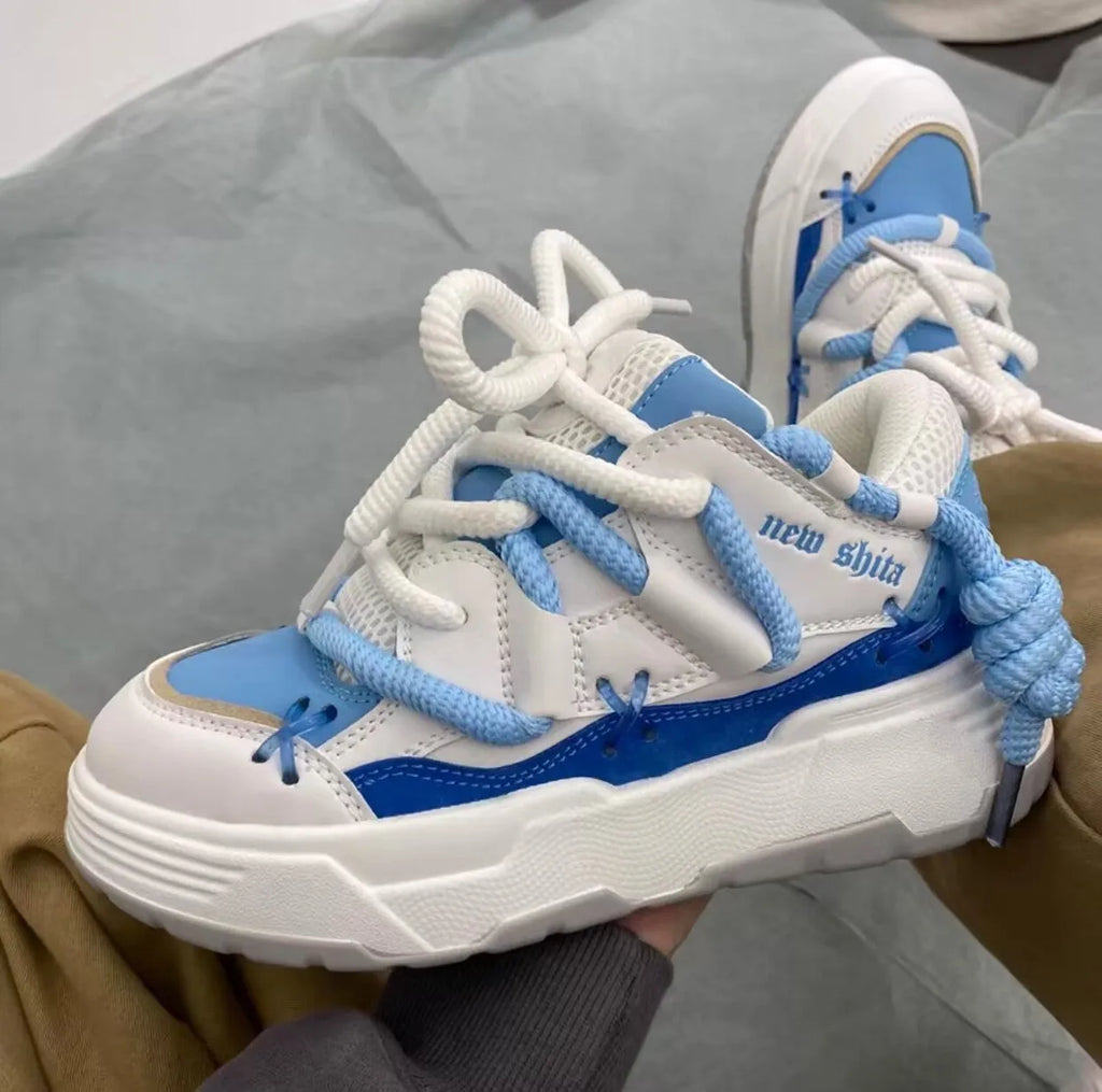 Women's grey retro chunky platform sneakers with a thick rubber sole and lace-up front.