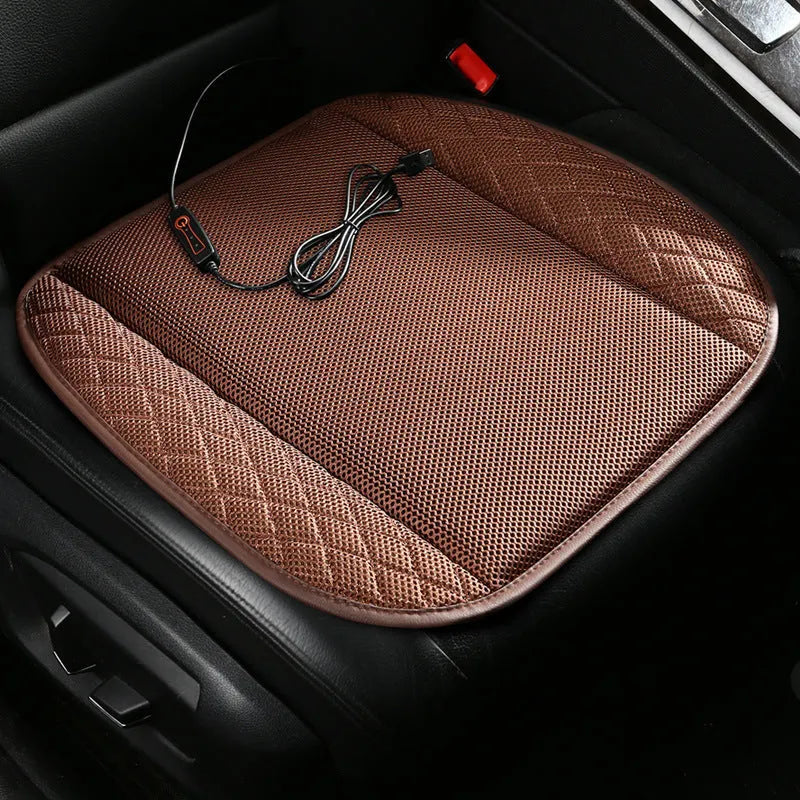 Black suede car seat cushion with USB cable and multiple cooling fans visible, placed on a car seat.