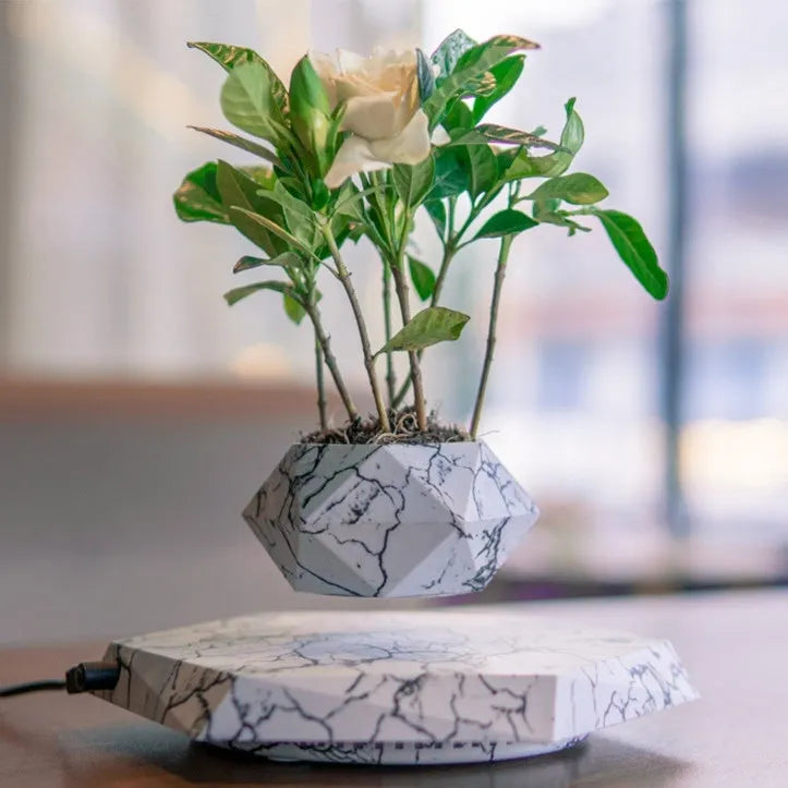 Marbled colour levitating plant pot floating above base with magnetic technology