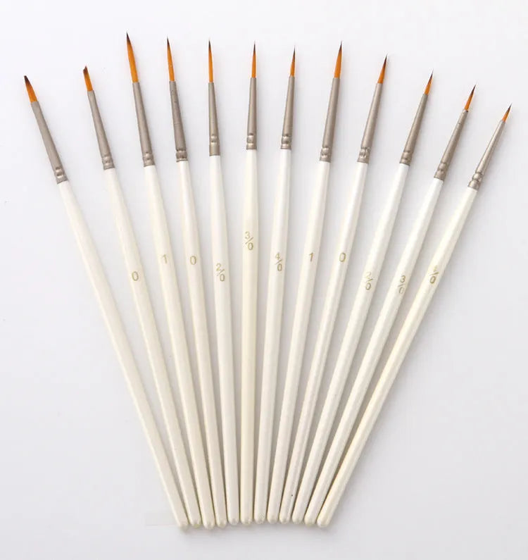 A 12-piece set of Pearl White artist brushes with a solid wood pen holder.