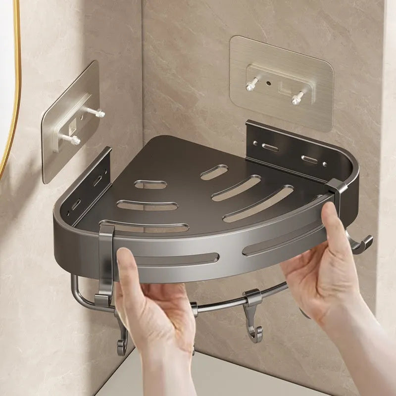 Gun grey metal fan-shaped corner bathroom shelf mounted punch-free on a wall, holding bathroom toiletries.
