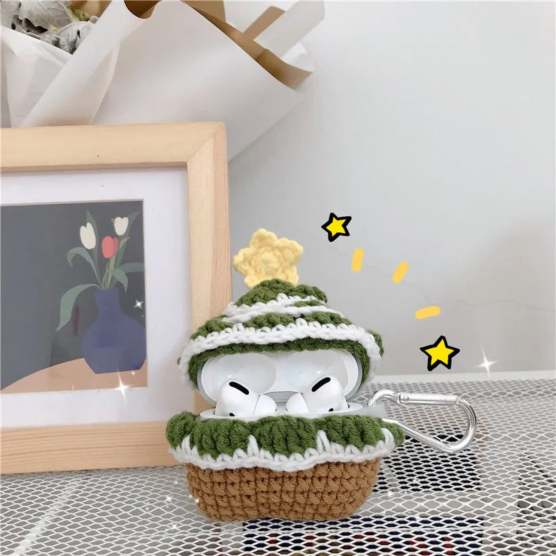 Green knitted Christmas tree flip-style headset case for AirPods with silver hook on white background