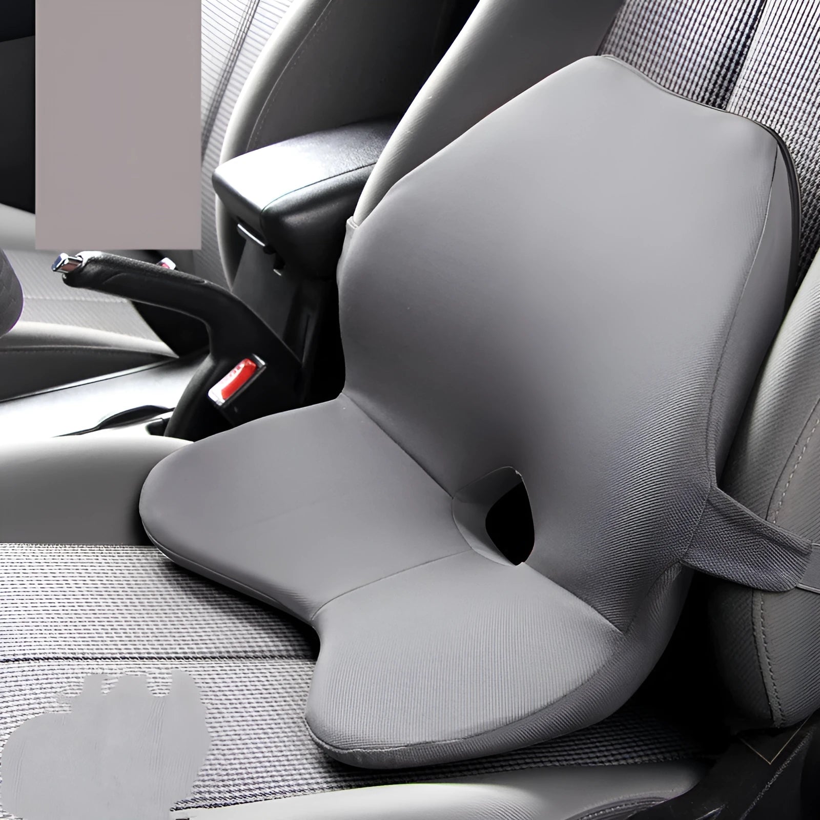 Black memory foam car lumbar support cushion with elastic straps, shown on a grey car seat.