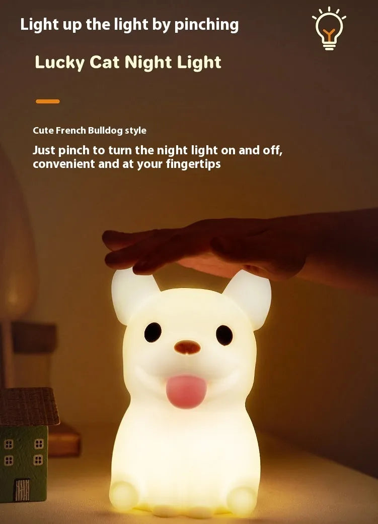 Soft silicone USB night light with dimmer in a cartoon animal design on a bedside table.