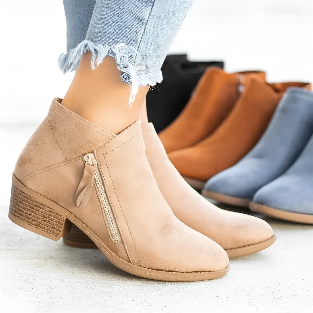 Women's blue suede Dr Martens ankle boots with side zip and chunky composite sole.