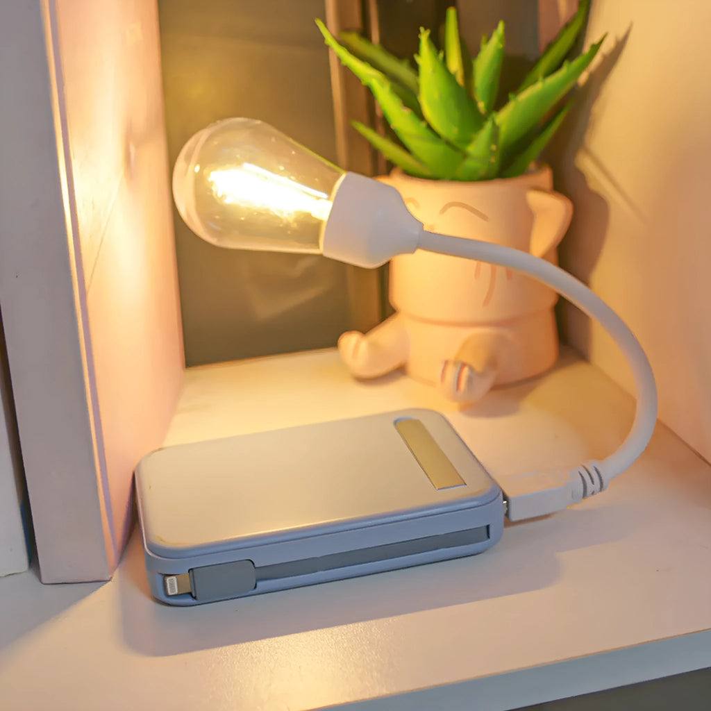 USB rechargeable folding night light with warm tungsten bulb illuminated.