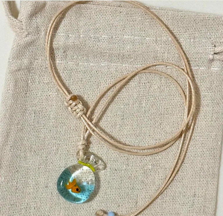Women's pendant necklace with coloured glaze charm on a cotton and linen clavicle chain in Small Fish Lucky Bag colour.