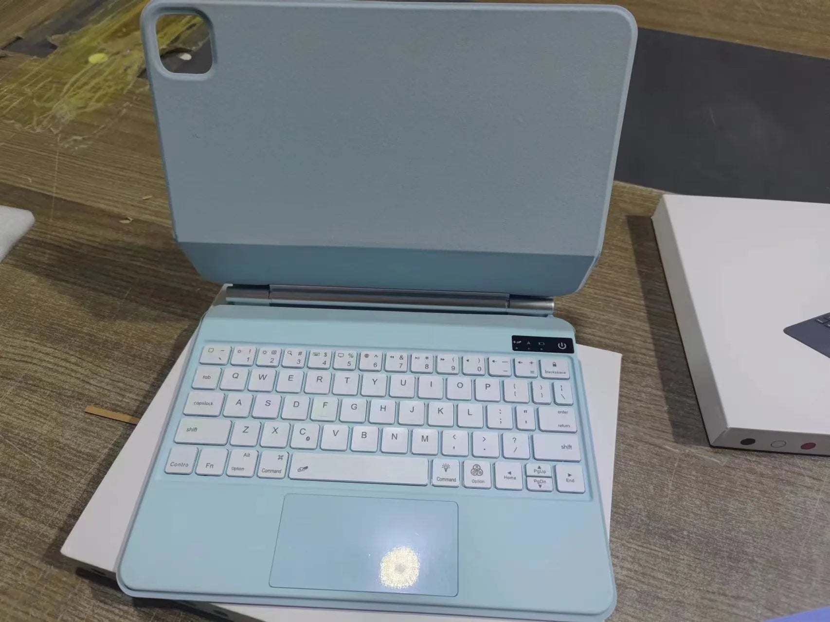 11-inch magnetic Bluetooth keyboard case for iPad in black, white, pink, purple, and blue colour options.