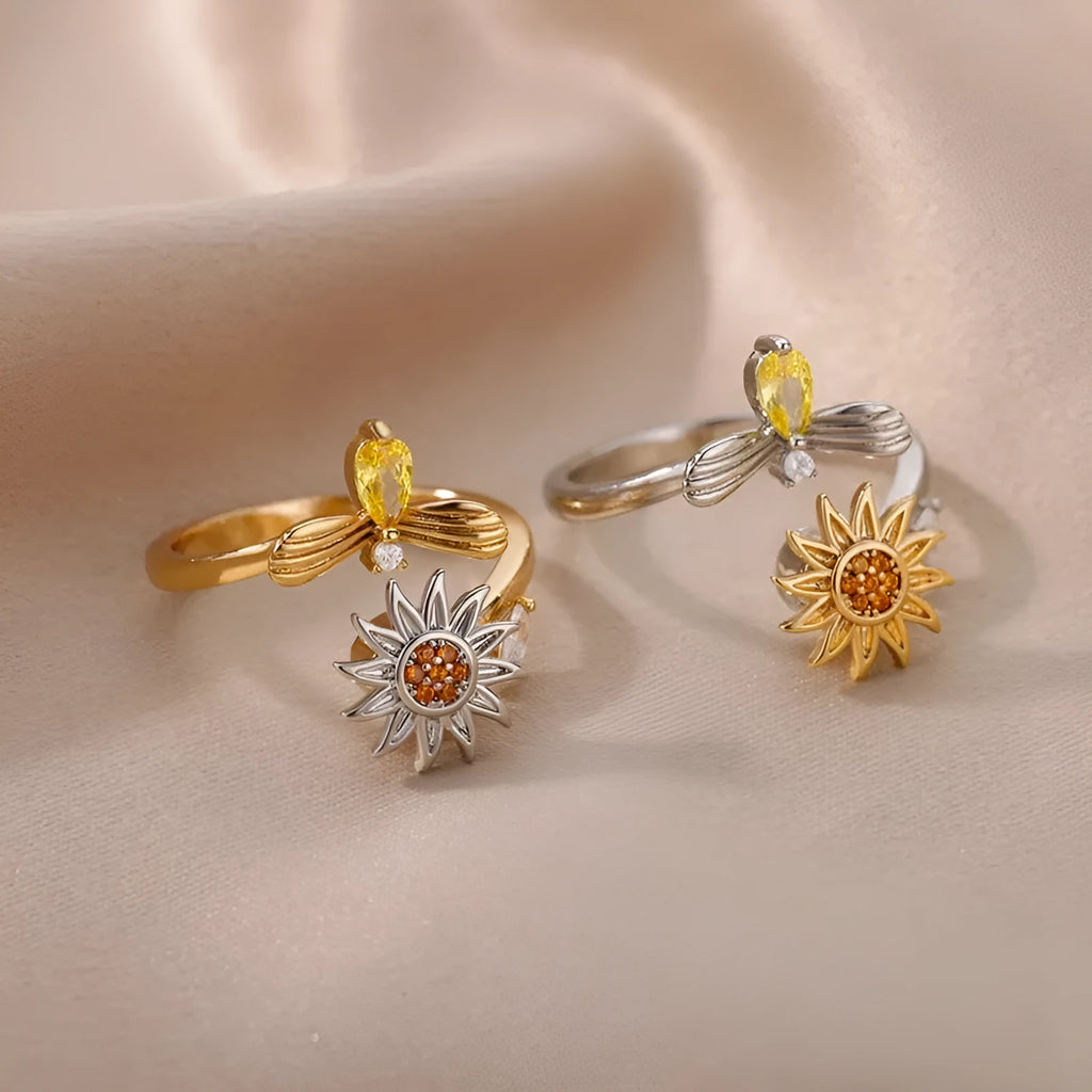 Gold and platinum adjustable geometric decompression spinner rings showing rotatable design