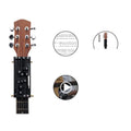 Black automatic guitar chord changing device for folk music beginners on a guitar neck.