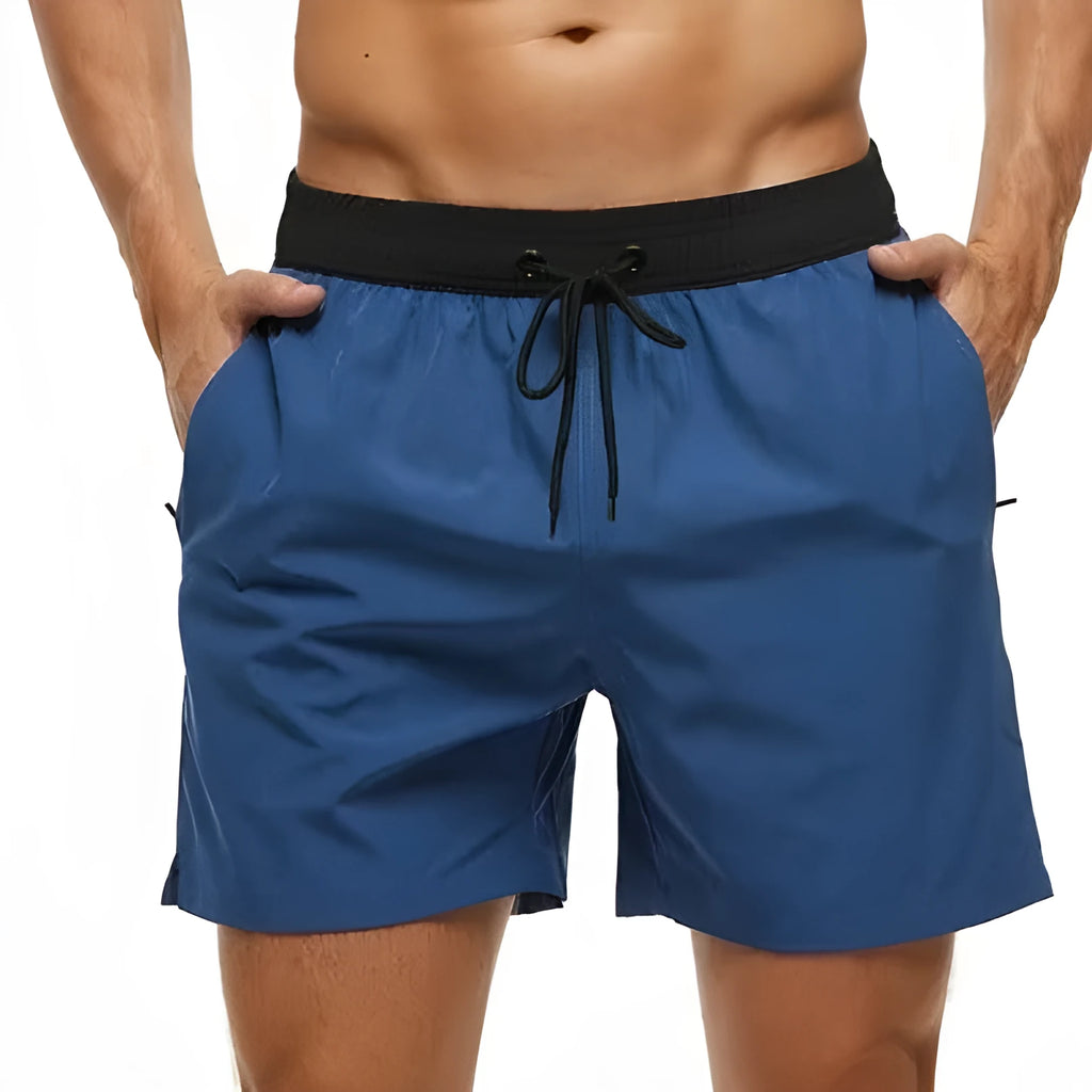 Men's blue athletic shorts with a drawstring waist, zipper pockets, and visible stitching detail.