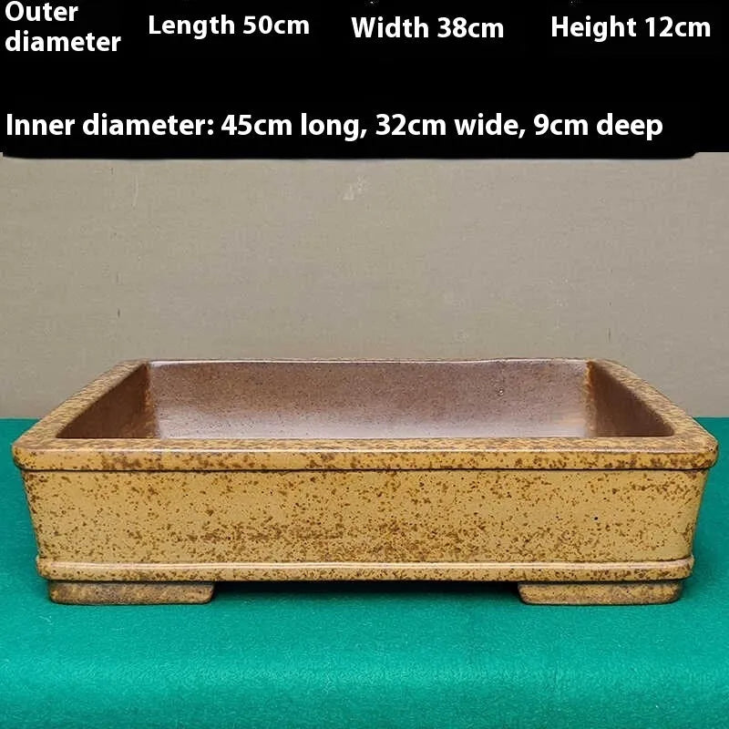Straight shallow rectangular Yixing Zisha purple sand flowerpot on ground.