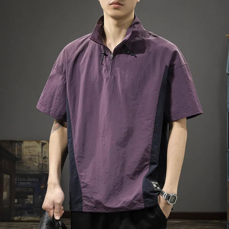 A brown men's loose-fit short-sleeve shirt with a half-zip front and stand collar.