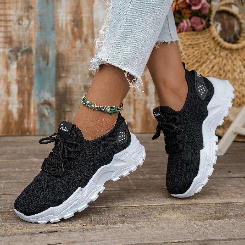 Women's Flyknit mesh casual sports shoes in various colours with flat heel and lace-up front.