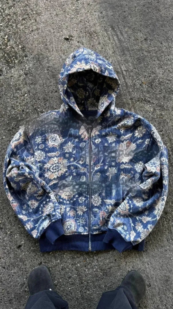 Man wearing a blue loose-fit hooded zip coat with long sleeves and digital printing.