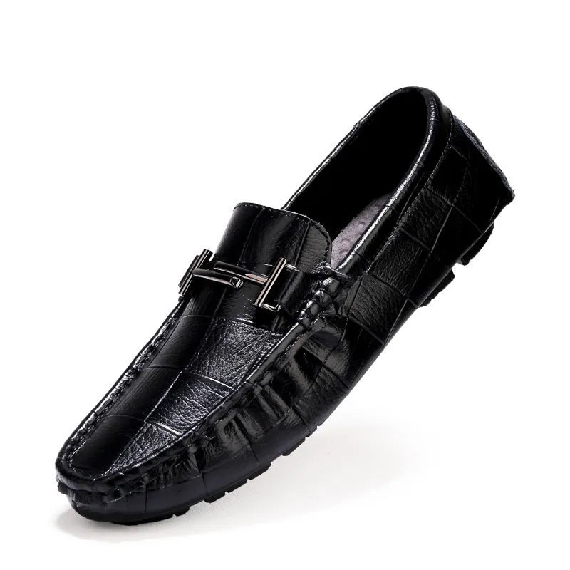 Men's black casual leather shoes with a silver buckle strap on a flat rubber sole.