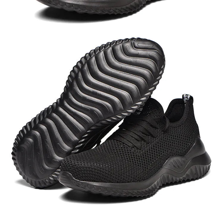 Black low-cut safety work shoes with a visible steel toe cap, shown on a grey background.