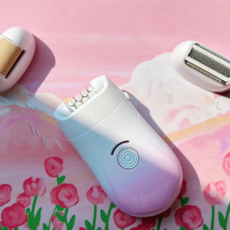 Pink three-in-one USB hair removal device with shaver head, grinding head, and skin rub accessories