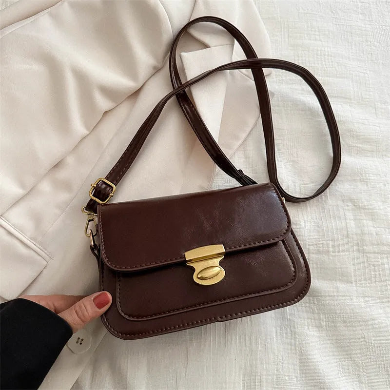 Retro-style square handbag in soft PU leather showing horizontal structure and shoulder strap