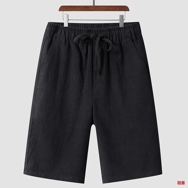 Man wearing beige loose-fit linen cropped shorts with an elastic mid waist.
