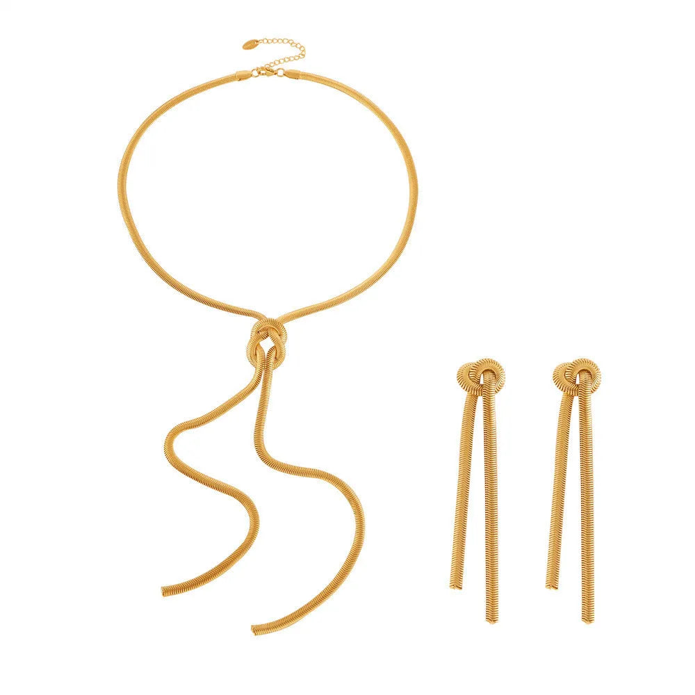 Gold knotted tassel pendant on long snake chain necklace with matching titanium steel earrings