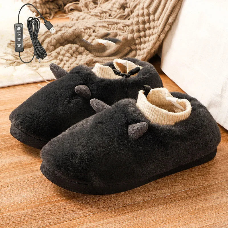 USB-powered electric heating slippers in black, shown with a USB cable plugged in.