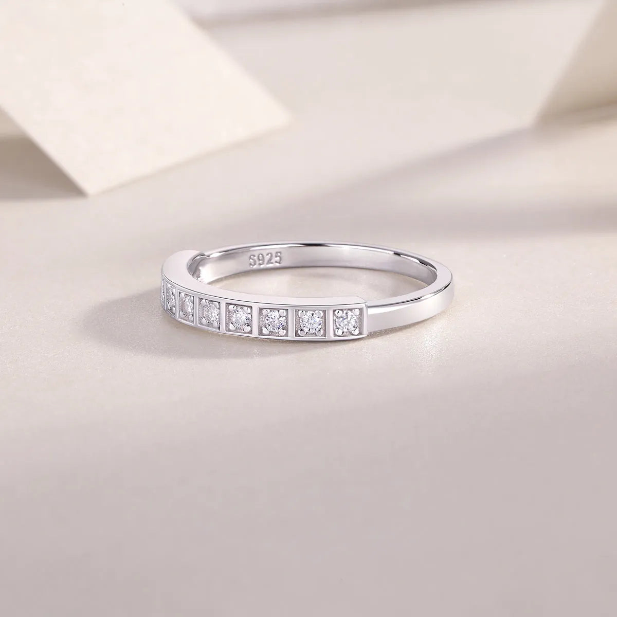 Moissanite wedding ring set on white background, S925 silver platinum plated, less than 0.1 carat stone