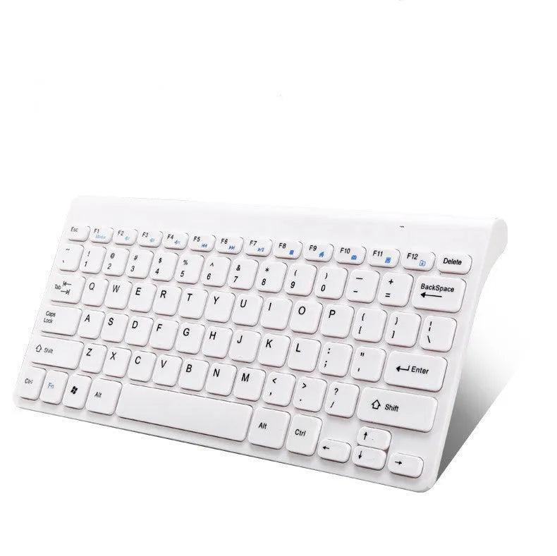 Black and white wireless keyboard and mouse set on a wooden desk.